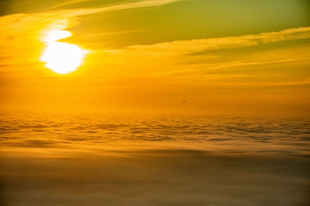 Aerial image Norderstedt - Airliner in the sunrise over the clouds after take-off in Hamburg Fuhlsbuettel in the height of Norderstedt in the state Schleswig-Holstein Germany