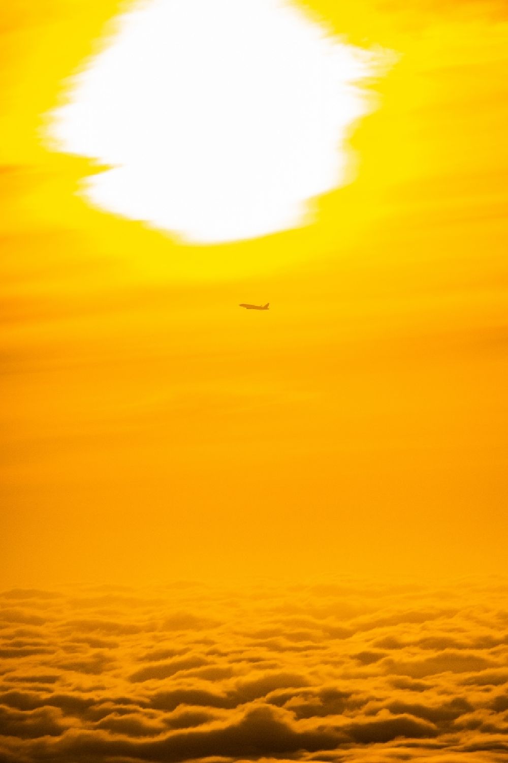 Aerial photograph Norderstedt - Airliner in the sunrise over the clouds after take-off in Hamburg Fuhlsbuettel in the height of Norderstedt in the state Schleswig-Holstein Germany