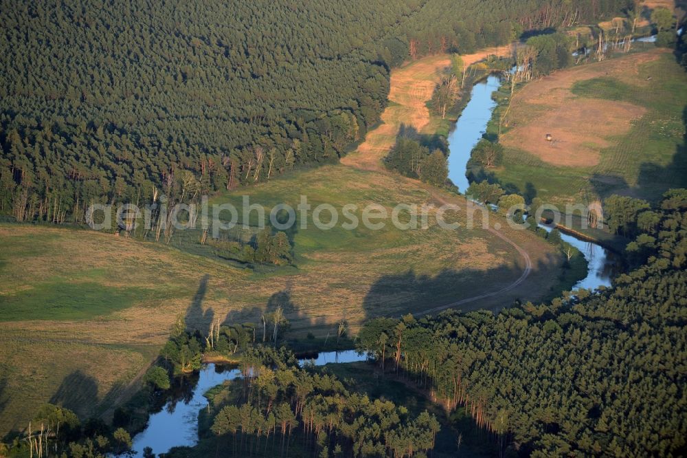 Aerial photograph Spreenhagen - Course of the river Spree in the area of the borough of Spreenhagen in the state of Brandenburg. The river takes its course in narrow bends between trees and forest in the low sunlight of dawn