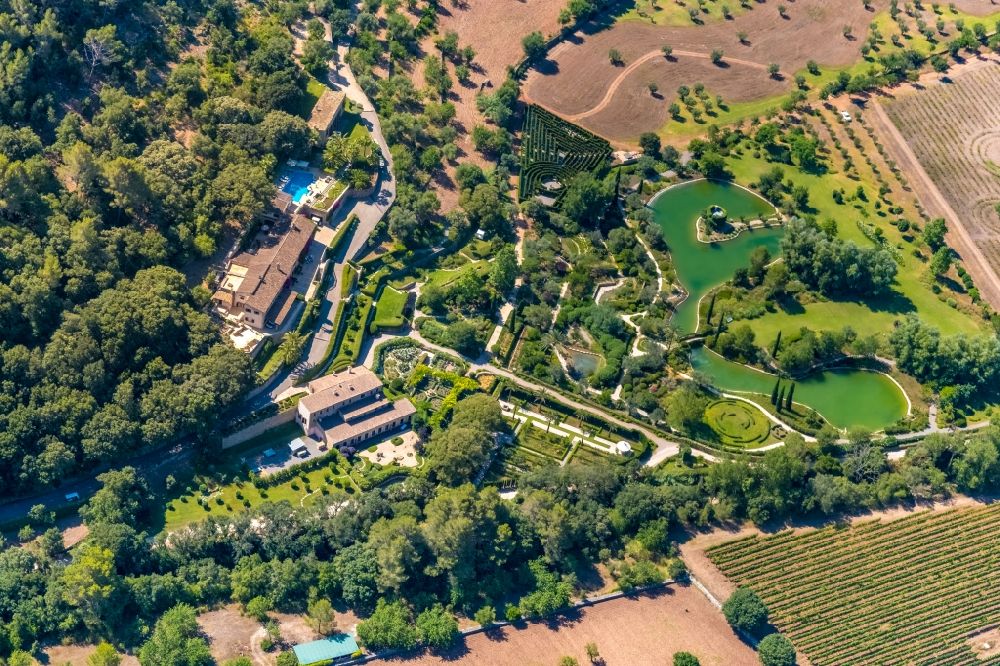 Pollenca from the bird's eye view: Luxury residential villa of single-family settlement with a maze and ponds in Pollenca in Islas Baleares, Spain