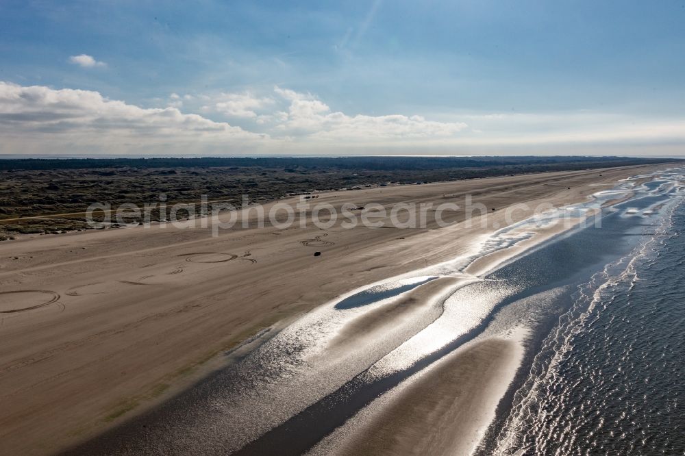 Fanö from the bird's eye view: Cars riding on the Beach along the West coast of Northsea island in Fanoe in, Denmark