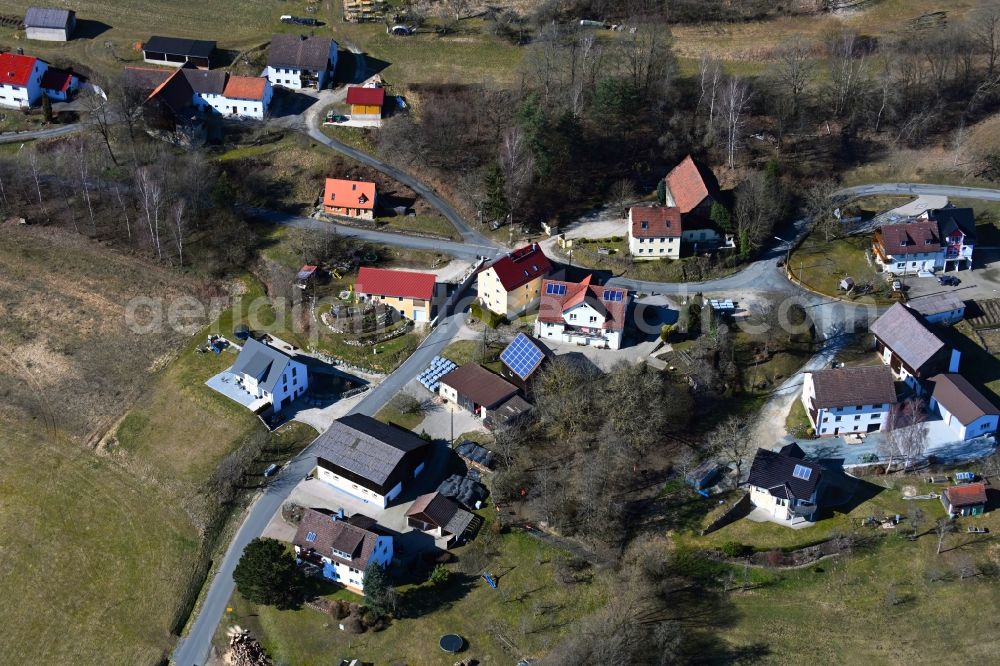 Aerial image Eichig - Surrounded by forest and forest areas center of the streets and houses and residential areas in Eichig in the state Bavaria, Germany