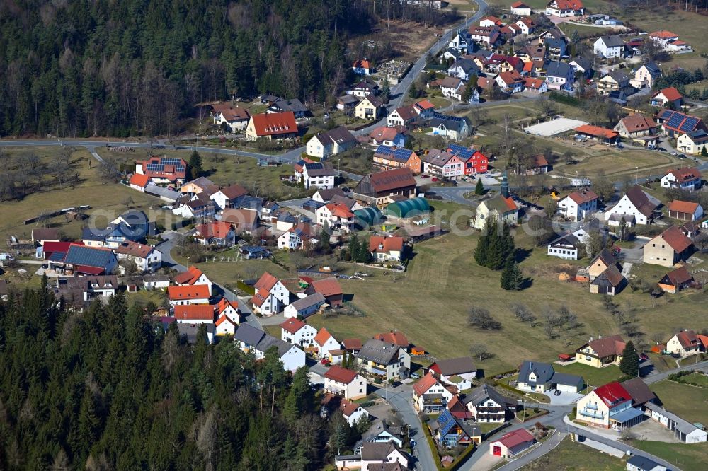 Geschwand from above - Surrounded by forest and forest areas center of the streets and houses and residential areas in Geschwand in the state Bavaria, Germany