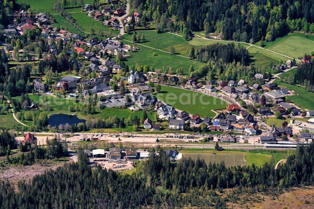 Hinterzarten from above - Surrounded by forest and forest areas center of the streets and houses and residential areas in Hinterzarten in the state Baden-Wuerttemberg, Germany