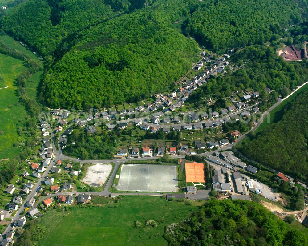 Langenaubach from the bird's eye view: Surrounded by forest and forest areas center of the streets and houses and residential areas in Langenaubach in the state Hesse, Germany