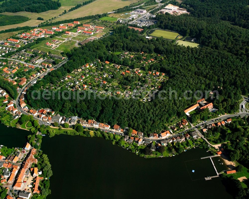 Mölln from the bird's eye view: Surrounded by forest and forest areas center of the streets and houses and residential areas in Mölln in the state Schleswig-Holstein, Germany