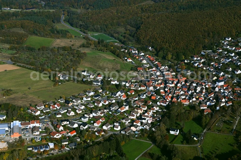Aerial image Pfaffenwiesbach - Surrounded by forest and forest areas center of the streets and houses and residential areas in Pfaffenwiesbach in the state Hesse, Germany