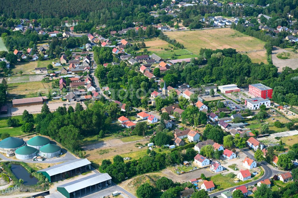 Schmachtenhagen from above - Surrounded by forest and forest areas center of the streets and houses and residential areas in Schmachtenhagen in the state Brandenburg, Germany