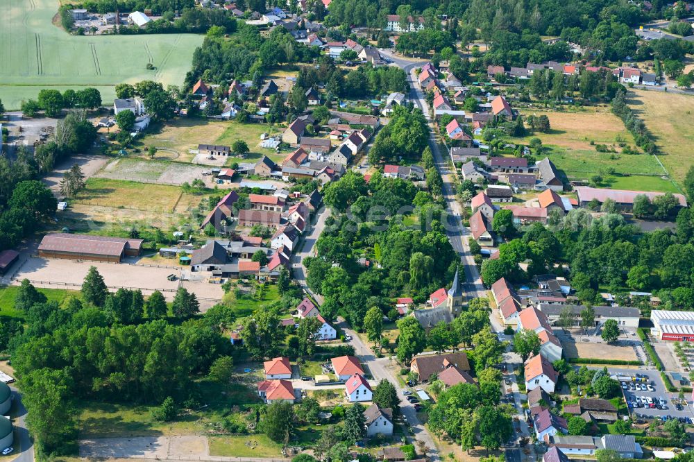 Aerial image Schmachtenhagen - Surrounded by forest and forest areas center of the streets and houses and residential areas in Schmachtenhagen in the state Brandenburg, Germany