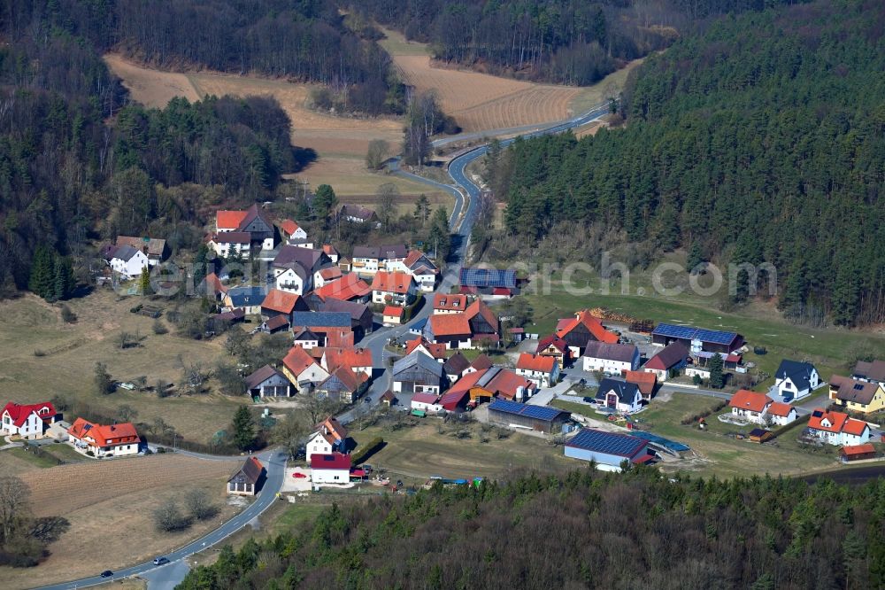 Stadelhofen from above - Surrounded by forest and forest areas center of the streets and houses and residential areas in Stadelhofen at Fraenkische Schweiz in the state Bavaria, Germany