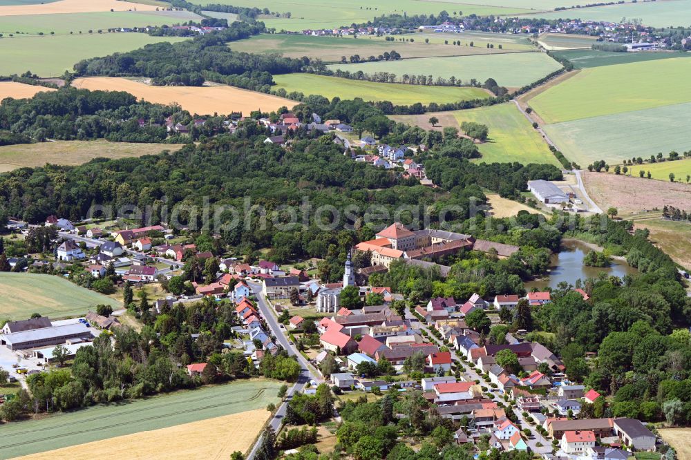 Wölkau from above - Surrounded by forest and forest areas center of the streets and houses and residential areas in Woelkau in the state Saxony, Germany