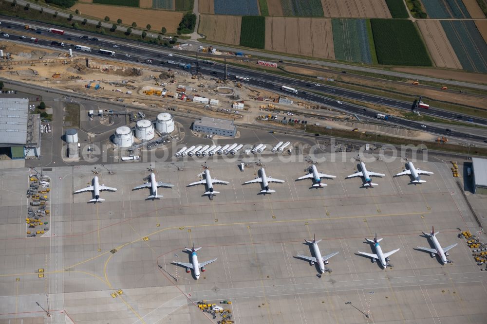 Aerial photograph Stuttgart - Passenger aircraft parked due to the crisis and pandemic on the parking position - parking area at the airport in Stuttgart during the corona lockdown in the state Baden-Wuerttemberg, Germany