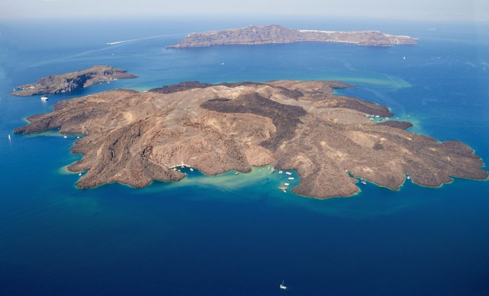 Nea Palemi from the bird's eye view: Volcanic island of Nea Palemi in the archipelago of Santorini in Greece. The uninhabited volcanic island in the Southern Aegean sea belongs to the municipality of Thira in the region of South Aegean