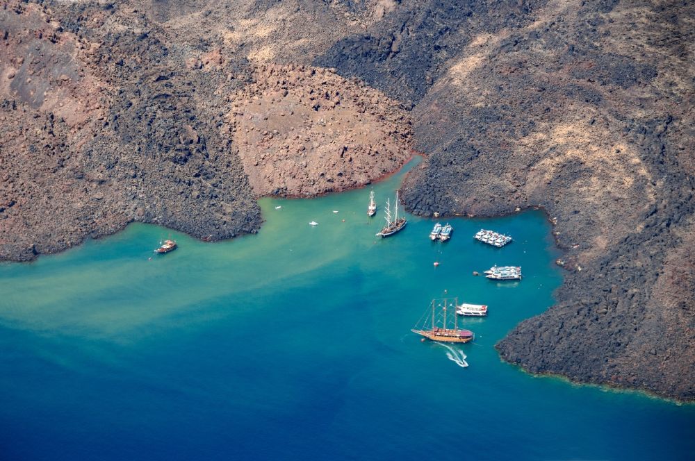 Aerial image Nea Palemi - Volcanic island of Nea Palemi in the archipelago of Santorini in Greece. The uninhabited volcanic island in the Southern Aegean sea belongs to the municipality of Thira in the region of South Aegean