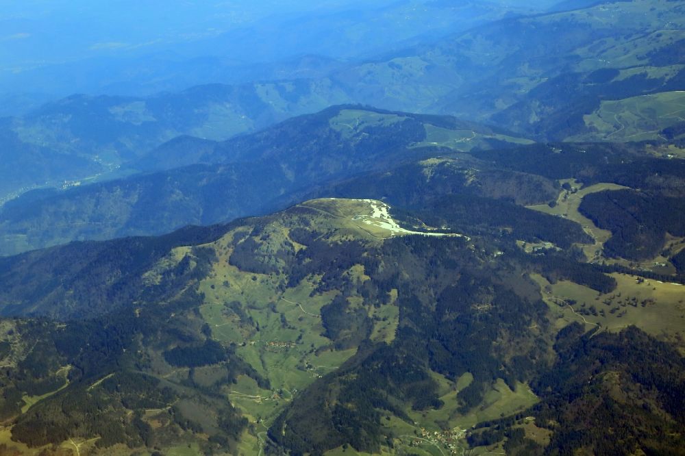 Schönenberg from above - Forest and mountain scenery in the Black Forest with last snow fields on the summit of mount Blechen in Schoenenberg in the state Baden-Wurttemberg, Germany