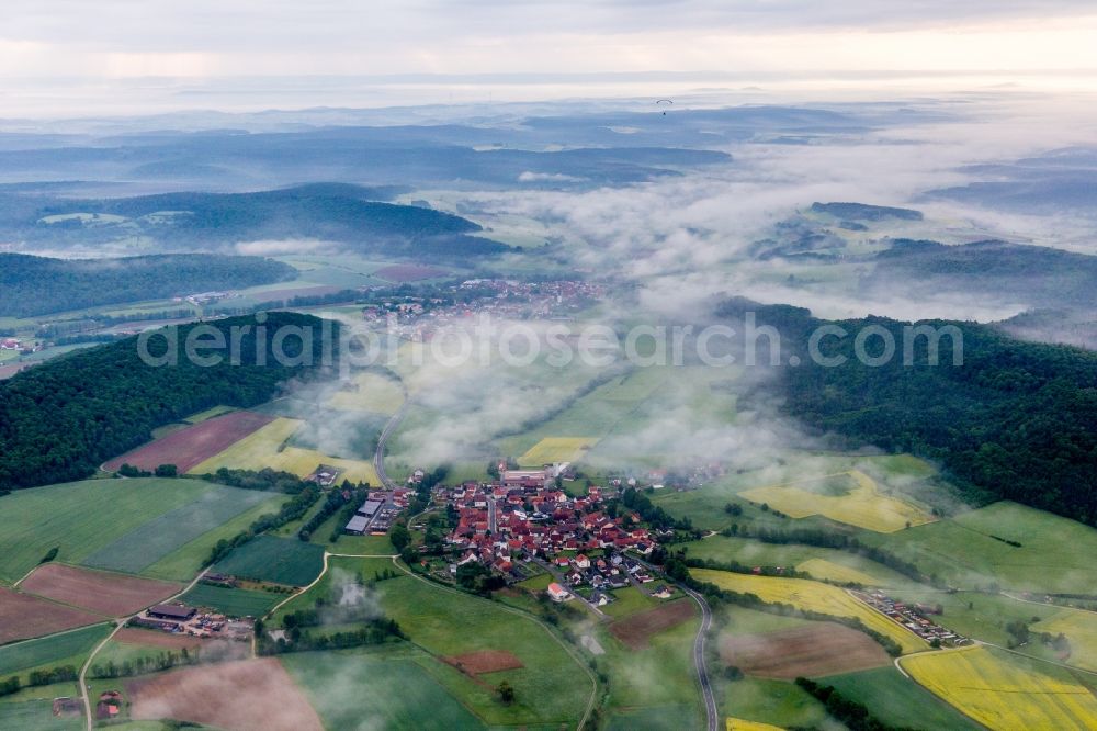 Wustviel from above - Forest and mountain scenery of Steigerwald in Fruehnebel in Wustviel in the state Bavaria, Germany