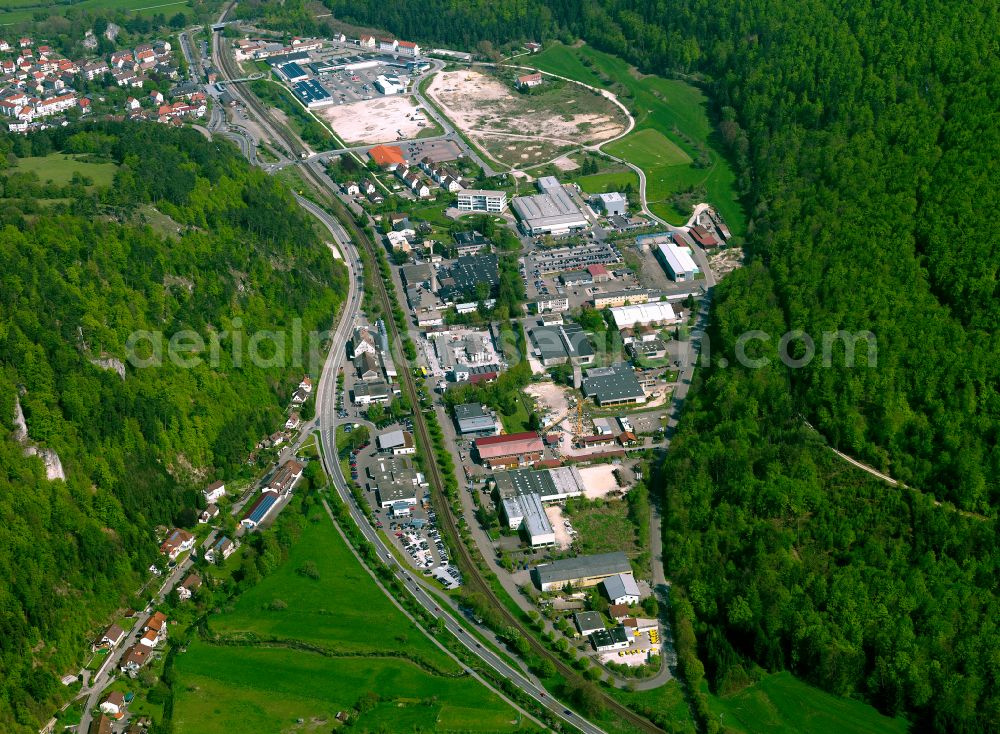 Blaubeuren from above - Industrial and commercial area in the middle of a wooded area in Blaubeuren in the state Baden-Wuerttemberg, Germany