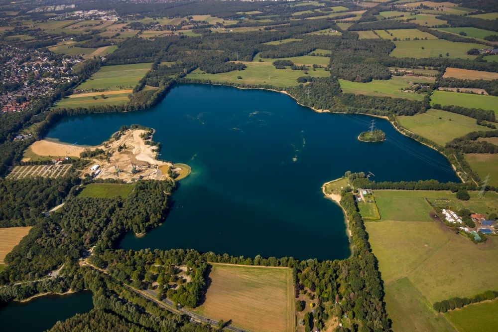 Hünxe from above - Forests on the shores of Lake Tenderingssee overlooking the gravel opencast in Huenxe in the state North Rhine-Westphalia, Germany