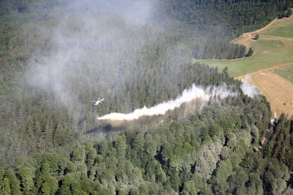 Aerial image Münstertal/Schwarzwald - Lime is spread by helicopter, to prevent acidification of the forest soil in the area of Muenstertal / Schwarzwald in Baden-Wuerttemberg. Acid rain favored in the high altitudes of the southern Black Forest the destruction of the forests