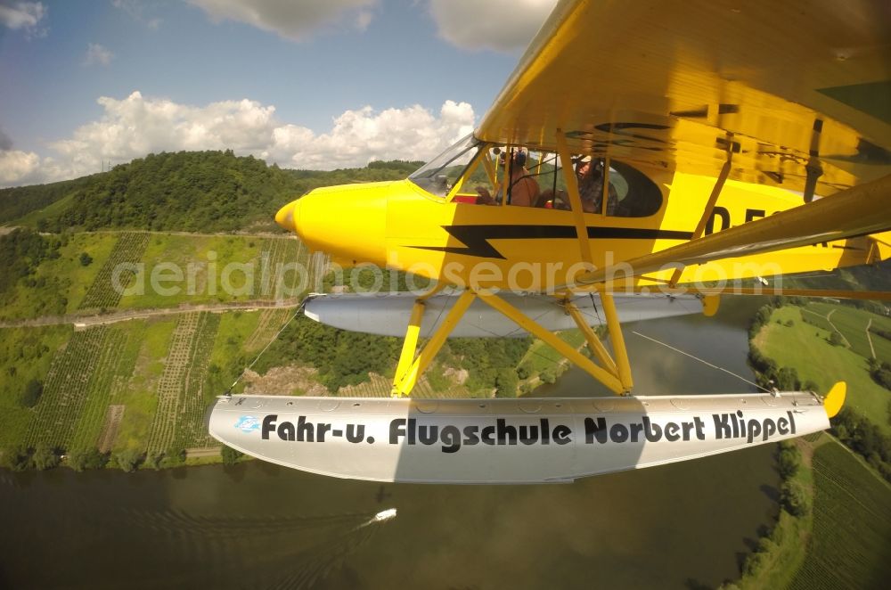 Zeltingen-Rachtig from above - Seaplane Piper PA-18 Super Cub on the Moselle with pines in Zeltingen in the state Rhineland-Palatinate. No use for reports on aviation accidents