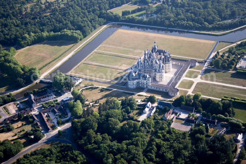 Aerial image Chambord - Building and castle park systems of water castle Chateau de Chambord on street Le Chateau in Chambord in Centre-Val de Loire, France