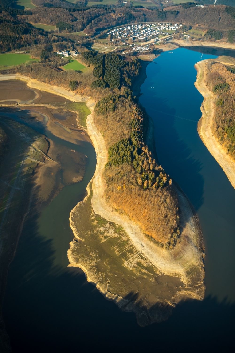 Olpe from above - Low water level and lack of water caused the shoreline areas to be exposed of Biggesee in Olpe in the state North Rhine-Westphalia, Germany