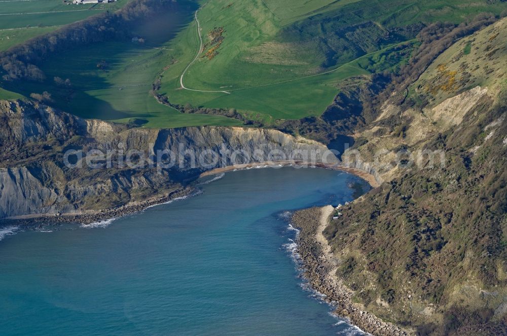 Aerial image Worth Matravers - Water surface at the bay along the sea coast of English Channel Chapman's Pool in Worth Matravers in England, United Kingdom