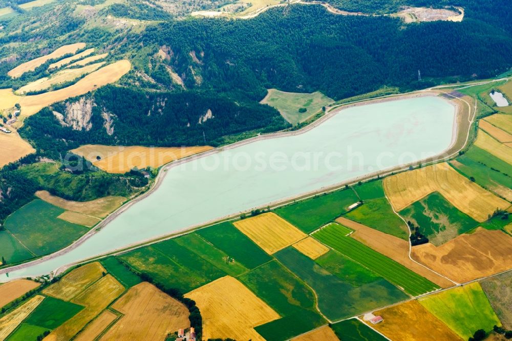 Aerial image Lazer - Water reservoir and lake for agricultural irrigation in summer from melting water in Lazer in Provence-Alpes-Cote d'Azur, France