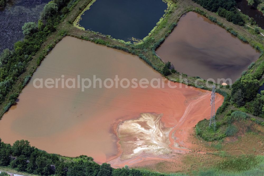 Aerial photograph Nalbach - Colorful water surface and water discoloration in open-cast mining, overburden and residual areas due to sulfuric acid compounds and oxidized iron compounds on Kindelfloss These are dissolved by rising groundwater and lead to acidification and clogging of the water. in Nalbach in the state Saarland, Germany