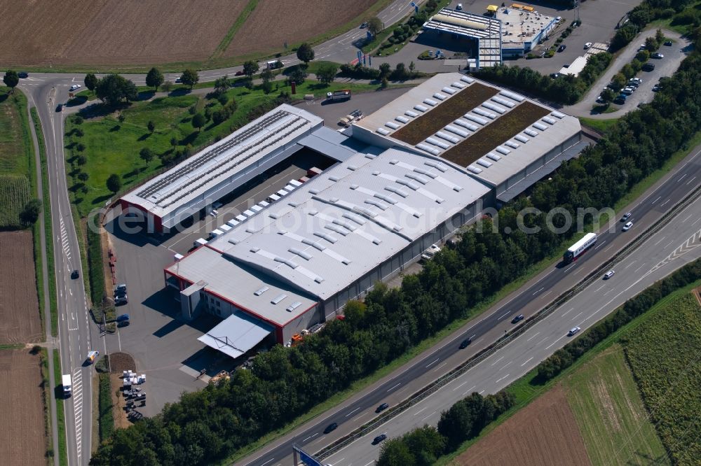 Ilsfeld from the bird's eye view: Building and production halls on the premises of LOeFFELHARDT Heilbronn GmbH at the Hauptstrasse in Ilsfeld in the state Baden-Wurttemberg, Germany