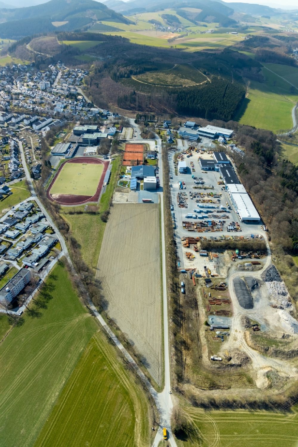Aerial photograph Schmallenberg - Factory premises of the Maschinen + Technik Sauerland Verwaltungs GmbH and sports grounds in Schmallenberg in the federal state of North Rhine-Westphalia, Germany