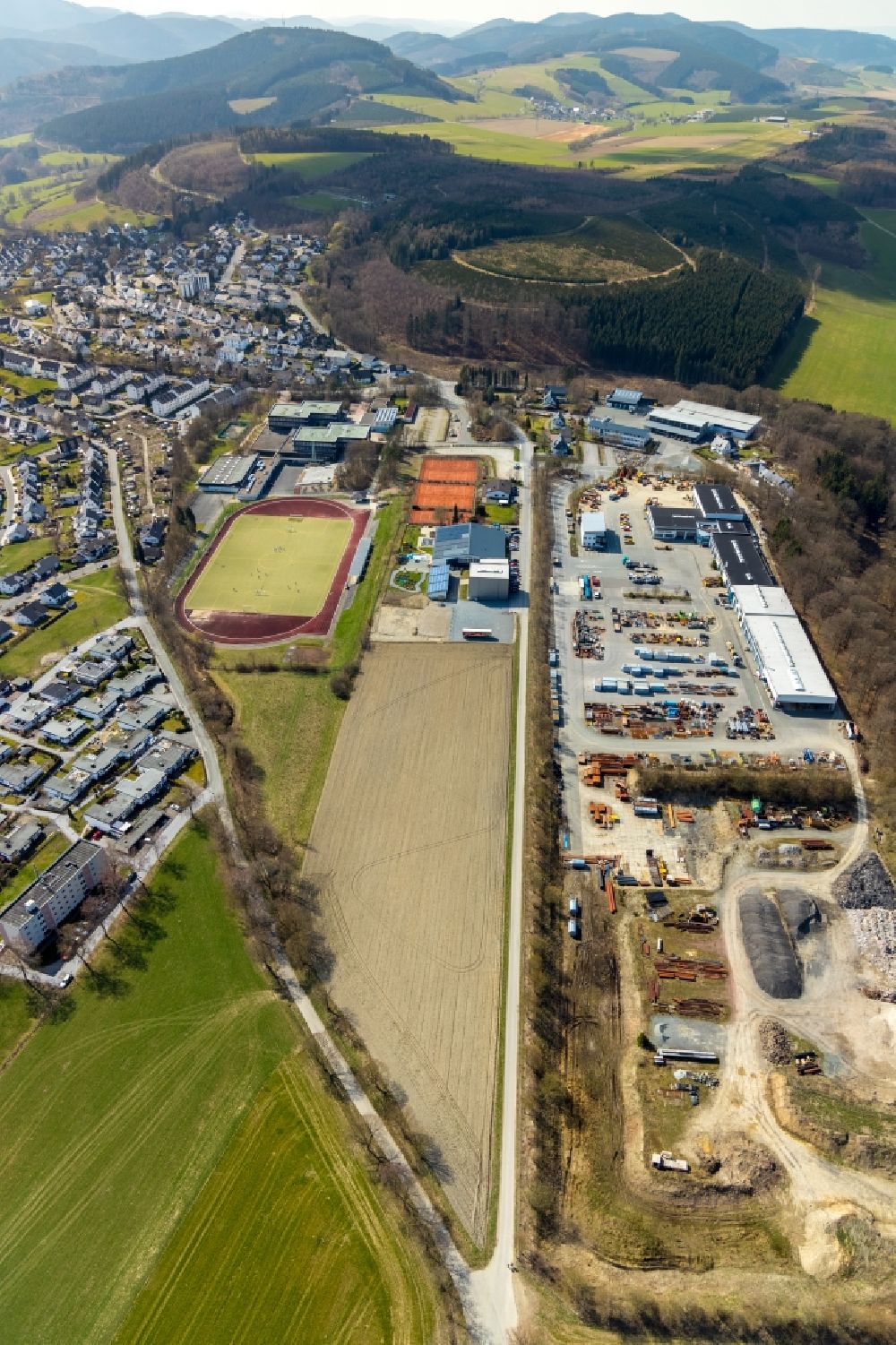 Schmallenberg from above - Factory premises of the Maschinen + Technik Sauerland Verwaltungs GmbH and sports grounds in Schmallenberg in the federal state of North Rhine-Westphalia, Germany