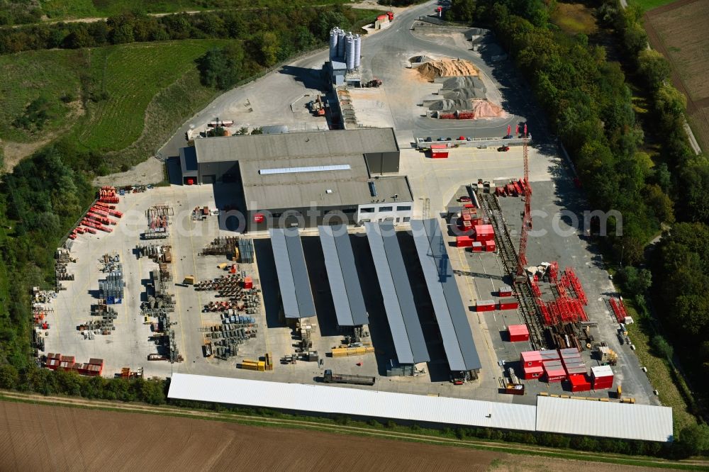 Bergrheinfeld from the bird's eye view: Building and production halls on the premises of Riedel Bau GmbH & Co. KG on Schweinfurter Strasse in Bergrheinfeld in the state Bavaria, Germany