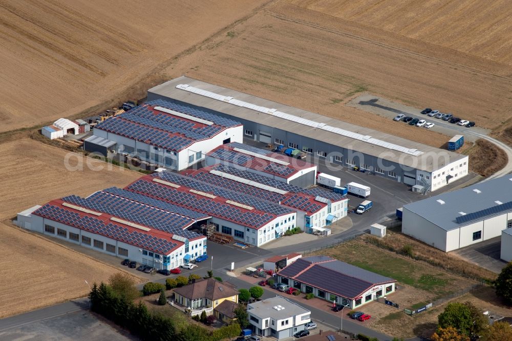 Aerial image Steinfeld - Building and production halls on the premises of SCHMELZMETALL Deutschland GmbH and of INHATEC GmbH & Co. KG on Raiffeisenstrasse in the district Hausen in Steinfeld in the state Bavaria, Germany