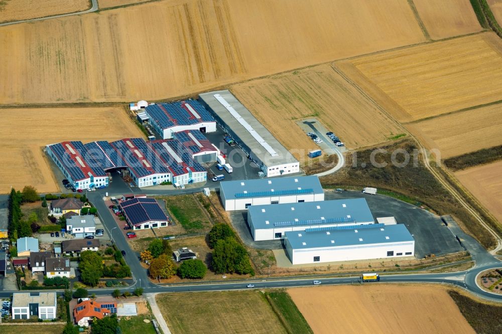 Steinfeld from the bird's eye view: Building and production halls on the premises of SCHMELZMETALL Deutschland GmbH and of INHATEC GmbH & Co. KG on Raiffeisenstrasse in the district Hausen in Steinfeld in the state Bavaria, Germany