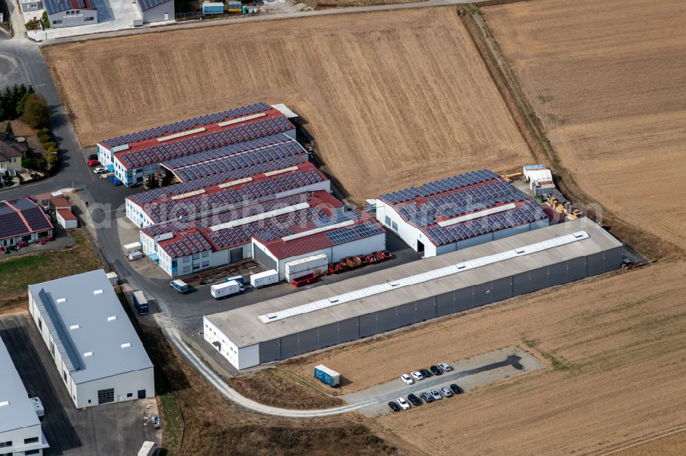 Steinfeld from the bird's eye view: Building and production halls on the premises of SCHMELZMETALL Deutschland GmbH and of INHATEC GmbH & Co. KG on Raiffeisenstrasse in the district Hausen in Steinfeld in the state Bavaria, Germany