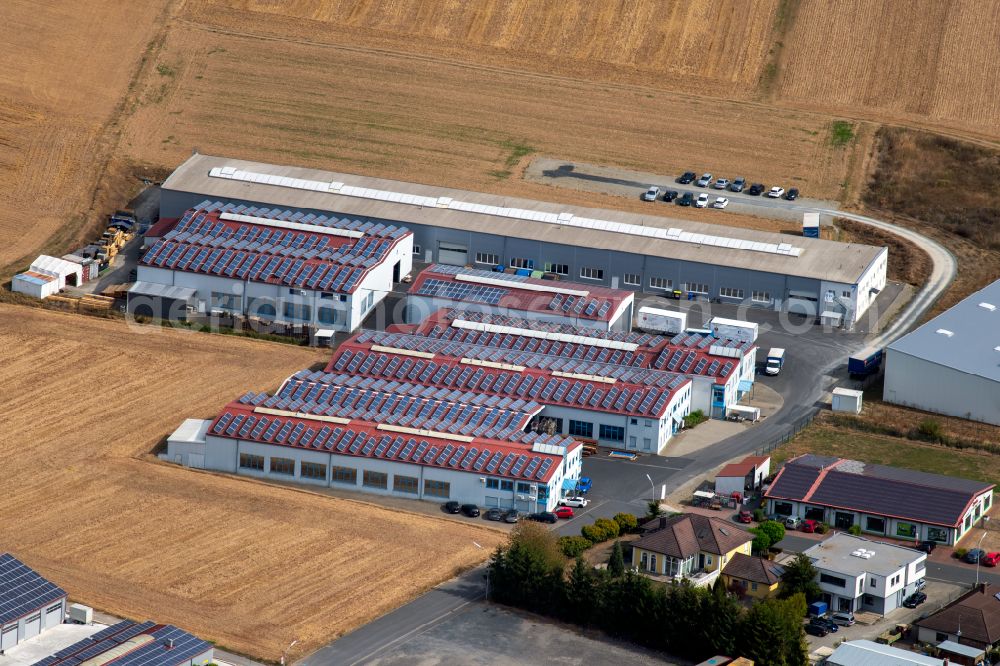 Aerial photograph Steinfeld - Building and production halls on the premises of SCHMELZMETALL Deutschland GmbH and of INHATEC GmbH & Co. KG on Raiffeisenstrasse in the district Hausen in Steinfeld in the state Bavaria, Germany
