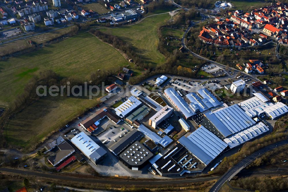 Mellrichstadt from the bird's eye view: Buildings and production halls on the factory site for sporting weapons and surface technology of Weihrauch & Weihrauch Sport GmbH & Co. KG on Industriestrasse in Mellrichstadt in the state Bavaria, Germany