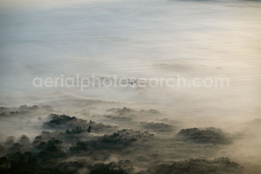 Aerial image Rosengarten - Embedded in a layer of fog due to the weather construction site for the new building in Rosengarten in the state Lower Saxony, Germany