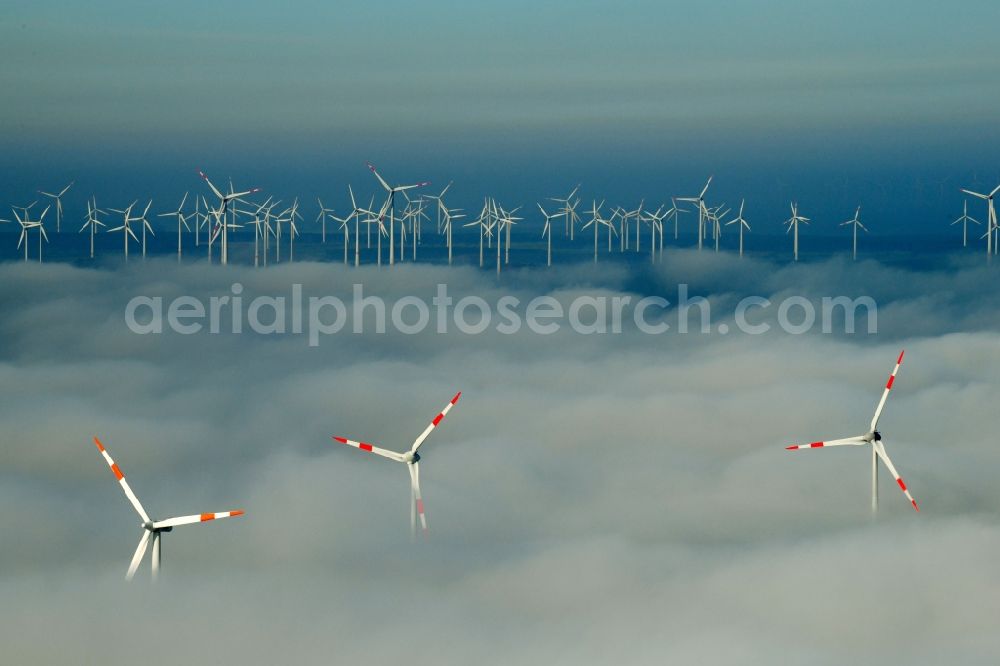 Waltersdorf from the bird's eye view: Weather-induced wind energy installations embedded in a fog layer on a field in Waltersdorf in the state Brandenburg, Germany
