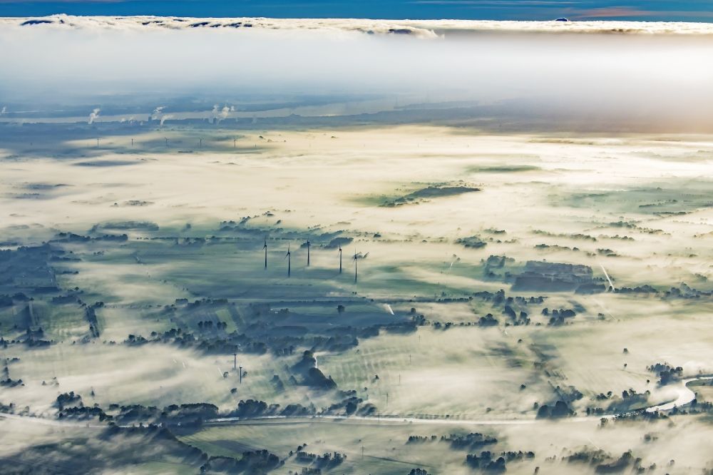 Engelschoff from the bird's eye view: Weather-induced wind energy installations embedded in a fog layer in Engelschoff in the state Lower Saxony, Germany