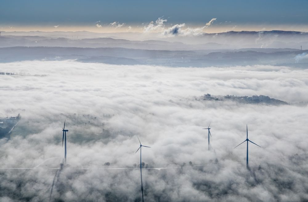 Wickede (Ruhr) from the bird's eye view: Weather-induced wind energy installations embedded in a fog layer in Wickede (Ruhr) in the state North Rhine-Westphalia, Germany