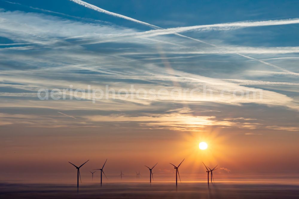 Dierbach from the bird's eye view: Weather-induced wind energy installations embedded in a fog layer of Windpark Freckenfeld bei Sonnenaufgang in Dierbach in the state Rhineland-Palatinate, Germany
