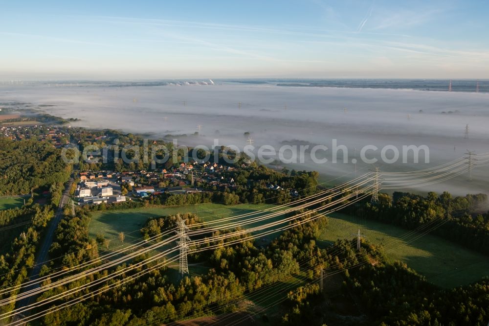 Aerial photograph Hollern-Twielenfleth - Embedded in a layer of fog due to the weather current route of the power lines and pylons in Hollern-Twielenfleth in the state Lower Saxony, Germany