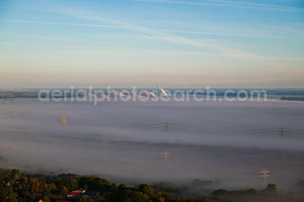 Hollern-Twielenfleth from above - Embedded in a layer of fog due to the weather current route of the power lines and pylons in Hollern-Twielenfleth in the state Lower Saxony, Germany
