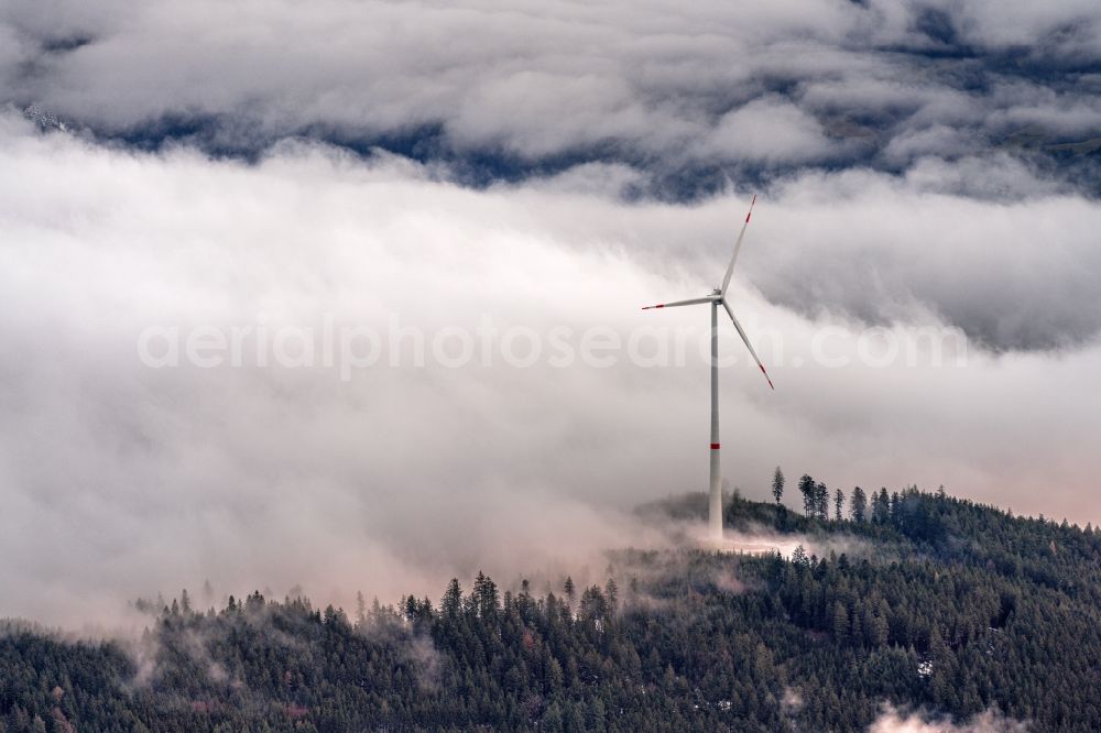 Fischerbach from above - Weather-induced wind energy installations embedded in a fog layer in Fischerbach in the state Baden-Wuerttemberg, Germany