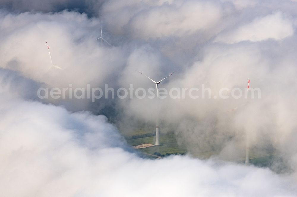 Aerial photograph Flachslanden - Weather-induced wind energy installations embedded in a clouds layer in Flachslanden in the state Bavaria, Germany