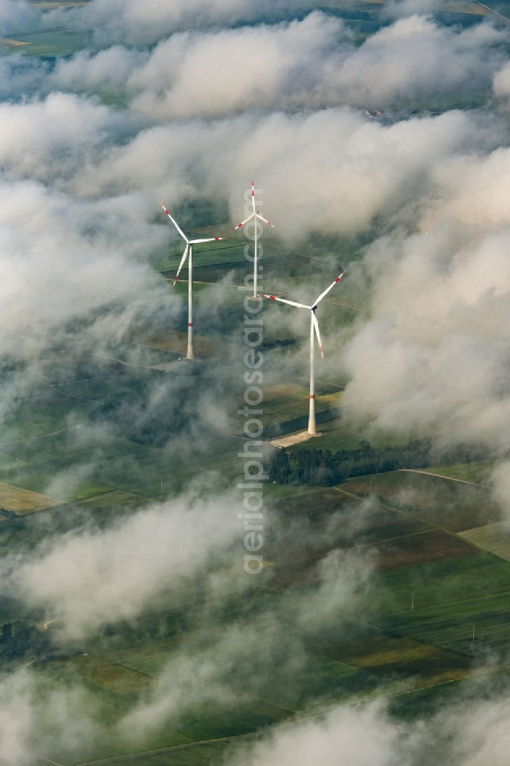 Titting from above - Weather-induced wind energy installations embedded in a cloud layer in Titting in the state Bavaria, Germany