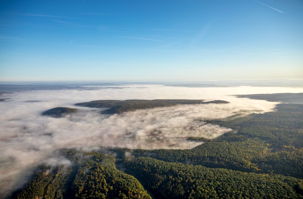Dassel from above - Weather with layered fog cover at a forest area in Dassel in the state Lower Saxony, Germany