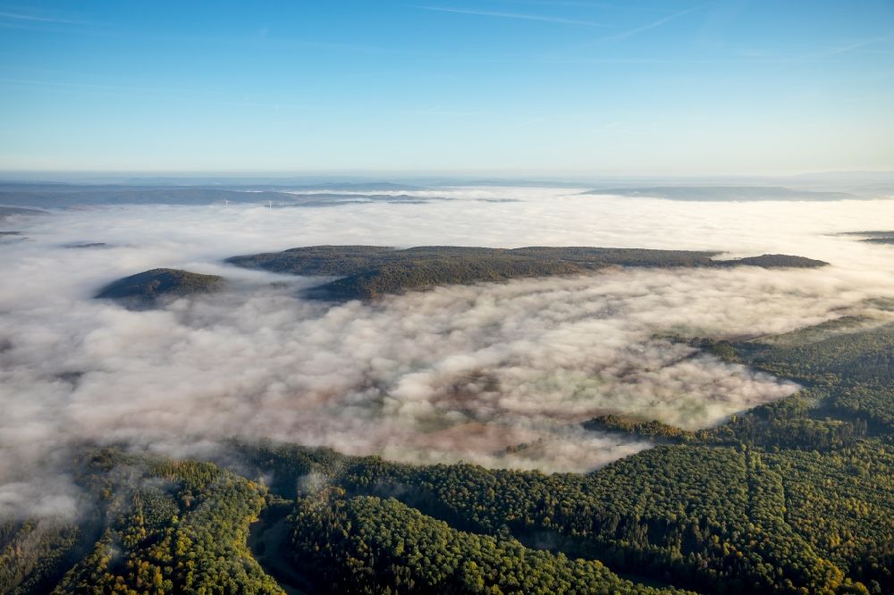 Dassel from the bird's eye view: Weather with layered fog cover at a forest area in Dassel in the state Lower Saxony, Germany
